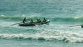 ALEXANDRA HEADLAND, QUEENSLAND, AUSTRALIA- APRIL 21, 2016: backlit shot of surf boats battling waves in a race