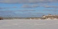 Alexandra Interprovincial bridge over frozen Ottawa river on winter day with snow