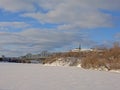 Alexandra Interprovincial bridge over frozen Ottawa river and Nepean lookout point on winter day with snow