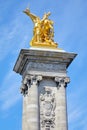 Alexandre III bridge golden statue with winged horse and column, blue sky in Paris, France Royalty Free Stock Photo
