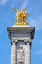 Alexandre III bridge golden statue with winged horse and column in a sunny day, blue sky in Paris Royalty Free Stock Photo