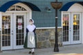 A female restaurant employee wearing a colonial woman dress costume