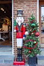 A tall nutcracker toy soldier and a Christmas tree Royalty Free Stock Photo