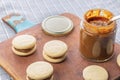 Alfajores de dulce de leche, traditional sweet from Argentina, on wooden board