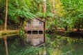 Alfred Nicholas memorial gardens lake in autumn with boat shed.