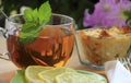 Mug of herbal tea, saucer with slices of lemon, mint leaves