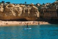 Man on standup paddle near idyllic beach in Algarve, Portugal