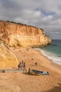 Sunny day at the picturesque Algarve beach with golden cliffs and azure waters