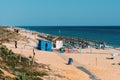 People relax at beach bar in Garrao Poente Beach in Algarve, Portugal