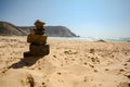 Algarve: Stone cairn at surfer beach Praia do Castelejo near Sagres and Vila do Bispo, Portugal Royalty Free Stock Photo