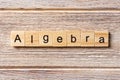 Algebra word written on wood block. Algebra text on table, concept