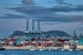 Night view of the port of Algeciras, full of containers and huge cranes with the Rock Royalty Free Stock Photo