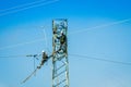 Algeciras, Spain - April 06, 2015. Workers checking the electricity wires in blue helmets