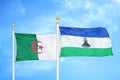 Algeria and Lesotho two flags on flagpoles and blue sky