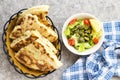 Algerian homemade bread named matlouh in arabic and salad bowl