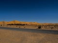 Algerian Sahara desert oasis of Thaghit Bechar Sand dunes behind the road