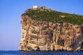 Alghero, Sardinia, Italy - Faro di Capo Caccia lighthouse at the limestone cliffs of the Capo Caccia cape at the Gulf of Alghero