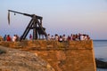 Alghero, Sardinia, Italy - Summer sunset view of the Alghero old town quarter with historic defense walls, fortifications and