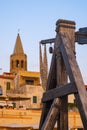Alghero, Sardinia, Italy - Summer sunset view of the Alghero old town quarter with historic defense walls, fortifications and