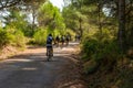 Algimia de Alfara, Spain 10/08/2020: Group of middle-aged cyclists riding on a natural road on a sunny day Royalty Free Stock Photo