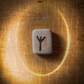 Algiz. Handmade scandinavian wooden runes on a wooden vintage background in a circle of light. Concept of fortune