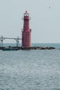 Algoma Pierhead Lighthouse - Lake Michigan, in Wisconsin, as a boat passes by Royalty Free Stock Photo