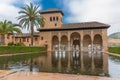View at the Partal Palace or Palacio del Partal , a palatial structure around gardens and water lake inside the Alhambra fortress Royalty Free Stock Photo