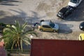 ALICANTE, SPAIN, APRIL 28 2021: two men pushing damaged car in the city of Alicante, in the Valencian Community, Spain