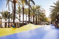 ALICANTE, SPAIN - AUGUST 24 2023: Celebration of Ukrainians independence day, people with giant blue - yellow flag