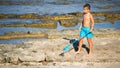 Alicante, Spain, August 30, 2019: Little boy holding a fishing net at the seashore Royalty Free Stock Photo