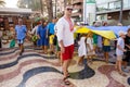 ALICANTE, SPAIN - AUGUST 24 2023:Ukrainians in national dress on march with giant blue-yellow flag