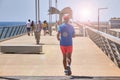 ALICANTE, SPAIN, CIRCA JUNE 2018, Active senior man jogging on the pier Royalty Free Stock Photo