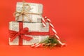 Gifts wrapped in old newspaper on red background