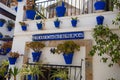 ALICANTE, SPAIN - JULY, 5 2023: Facade of house with blue pots in Santa Cruz district