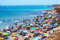 Alicante, Spain, July 23, 2019: Aerial view of Mil palmeras beach. Crowded beach in Alicante during summertime in 2019