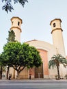 ALICANTE, SPAIN - JULY 5 2023: Building of the modern church, city street. Church facade, green trees, christian church