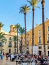 ALICANTE, SPAIN - JUNE 3, 2023: Calle Mayor square in Alicante with its palm trees and outdoor cafe. Spanish architecture and palm