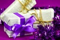 Gifts wrapped in old newspaper on purple background