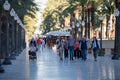 People walking on the Paseo Maritimo in the touristic city of Alicante in Spain in 2022 Royalty Free Stock Photo