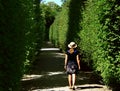 Women between hedgerows Royalty Free Stock Photo