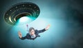 Alien abduction concept. Young man is abducted by UFO. Royalty Free Stock Photo