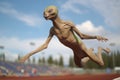 alien athlete jumping during high-flying leap in track and field event