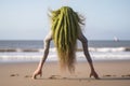 alien attempting handstand on the beach, with ocean breeze in its hair Royalty Free Stock Photo