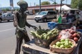 alien, browsing produce at farmers market, with basket in hand