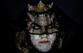 Alien, demon, sorcerer makeup. Demon on black background, close up. Dark arts concept. Senior man with white beard