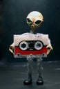 alien with a microcassette in his arms Royalty Free Stock Photo