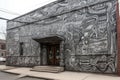 alien mural, with intricate details and hidden messages, covering entire building facade