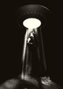 Alien spaceship kidnapping a human with the abduction ray. Retro styled poster with woman or man taken by the ufo or