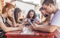 Alienation addiction. Friends sitting in cafe, typing on their phones Royalty Free Stock Photo