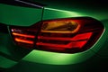 Alight rear lights green BMW M4 tuning in the dark garage